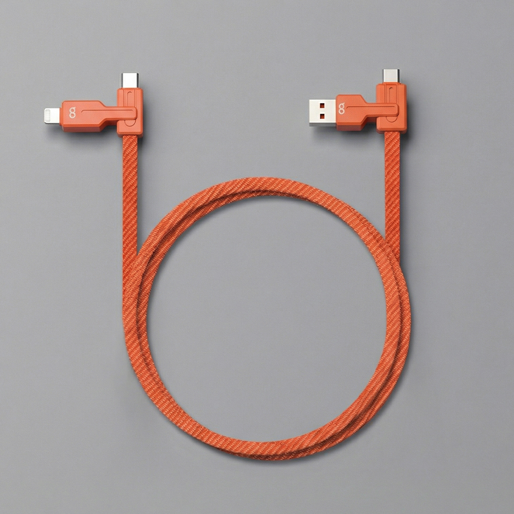 USB-C와 라이트닝 커넥터가 양쪽에 장착된 오렌지색 케이블이 회색 배경에 펼쳐져 있고 상단의 커넥터 부분이 명확하게 보이는 구성도 사진